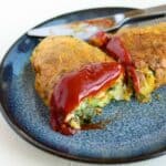 avocado omelet on a dark blue plate