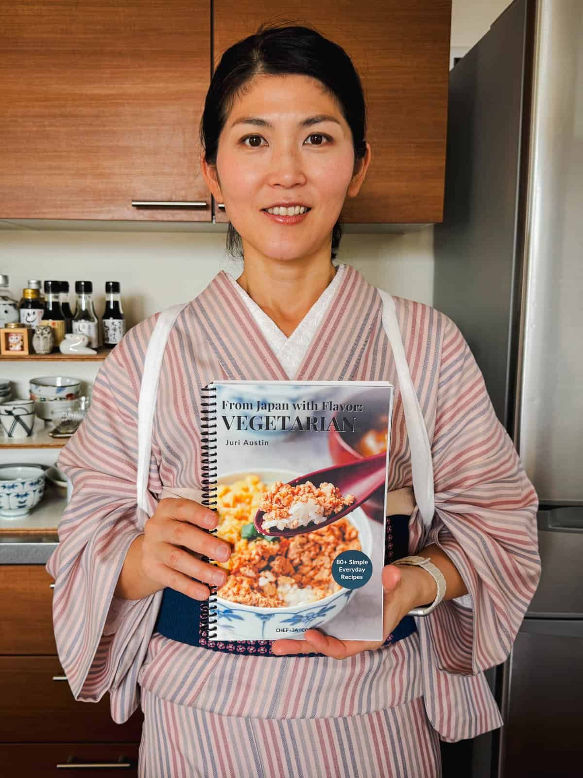 Juri holding a vegetarian cookbook.