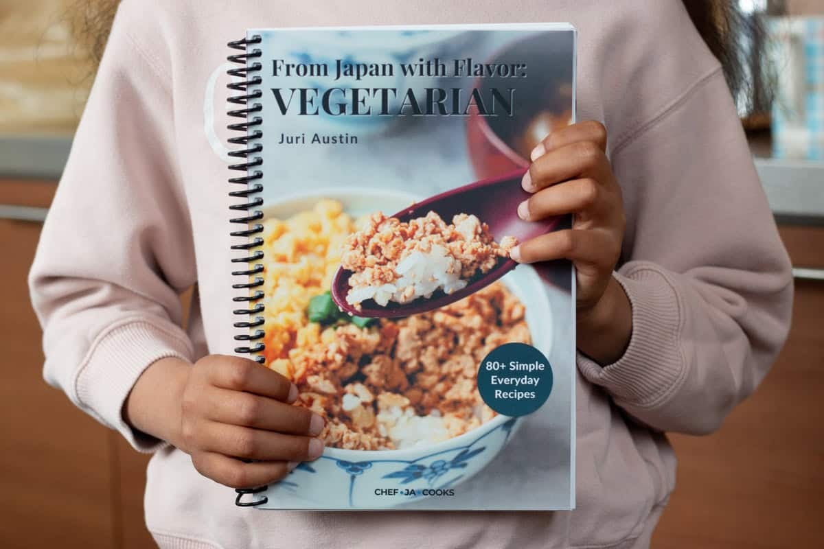 Holding vegetarian cookbook.