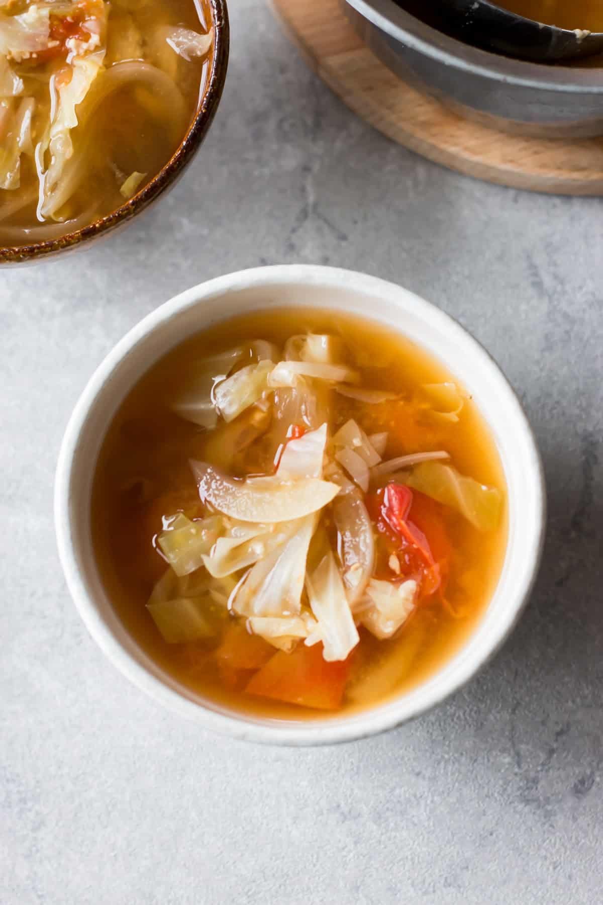 Cabbage and tomato miso soup served in a bowl.