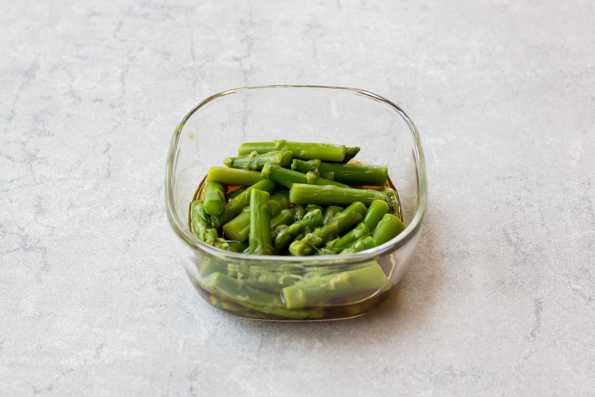 Asparagus ohitashi served on a small plate.