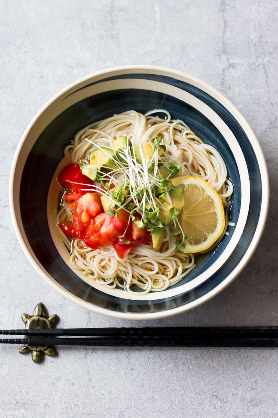 Cold somen noodles with avocado and tomato served in a bowl.