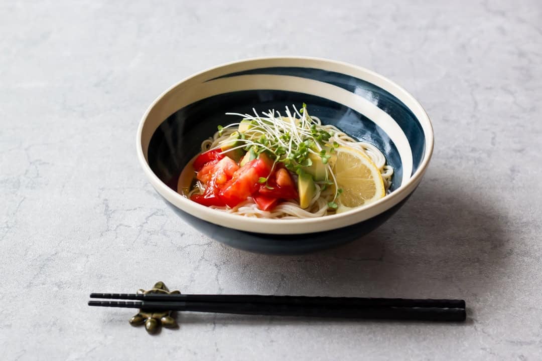 Cold somen noodles with avocado and tomato served in a bowl.