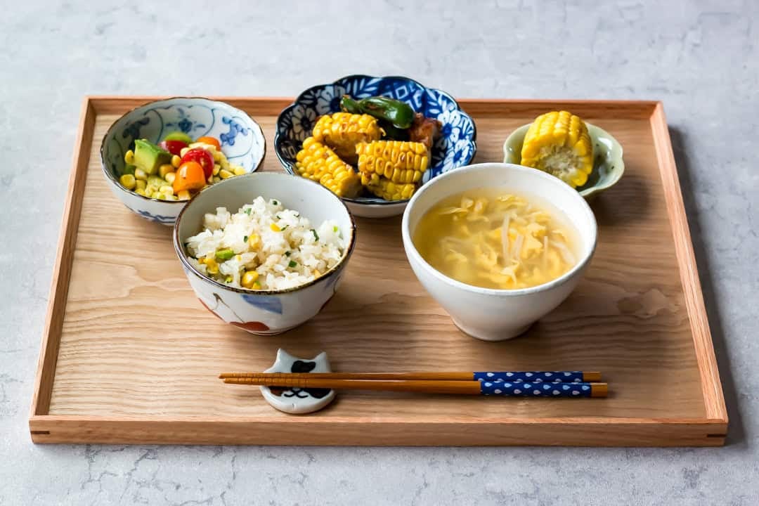 Japanese meal set with corn dishes.