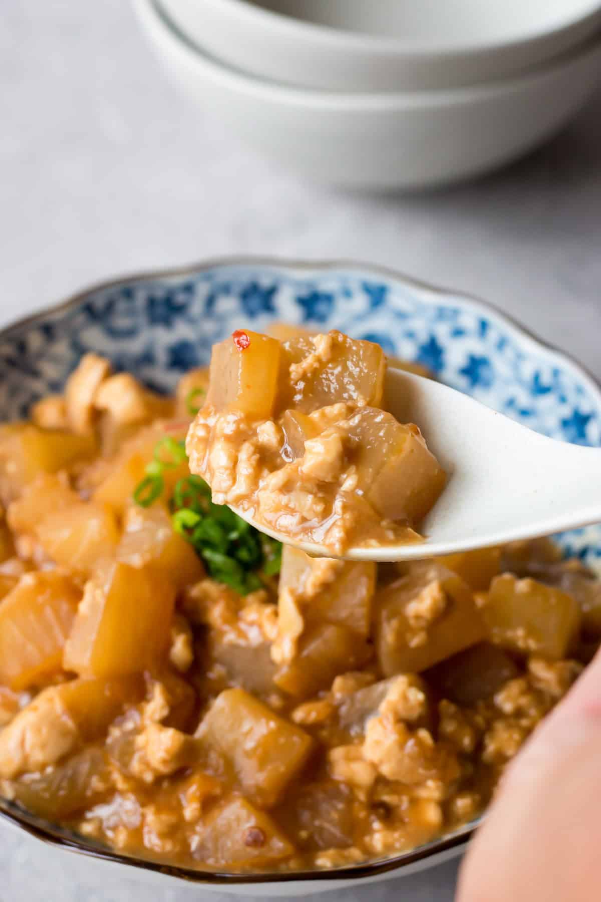 Daikon Simmered in Spicy Miso Sauce served in a bowl.